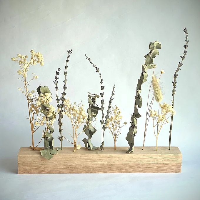 A captivating arrangement of dried flowers in a stylish vase, perfect for adding a touch of natural elegance to any home.